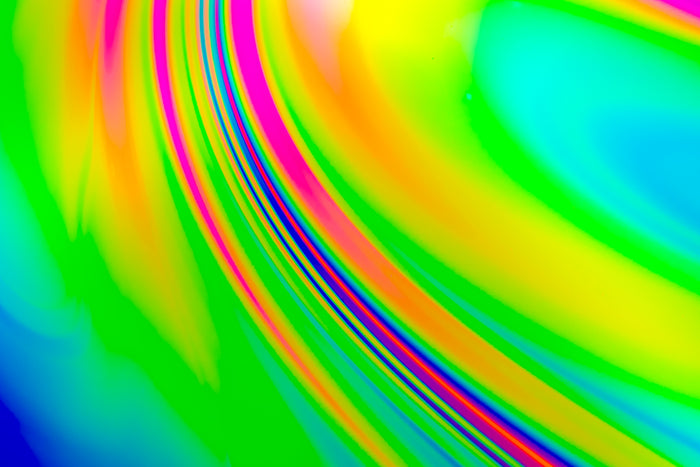 Vibrant, iridescent, abstract photograph of a soap film. Art made by science with light literally dancing