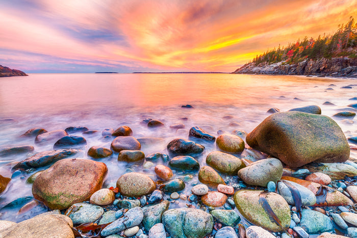 Incredible, vivid, colorful sunset photograph from Cobblestone beach Acadia National Park