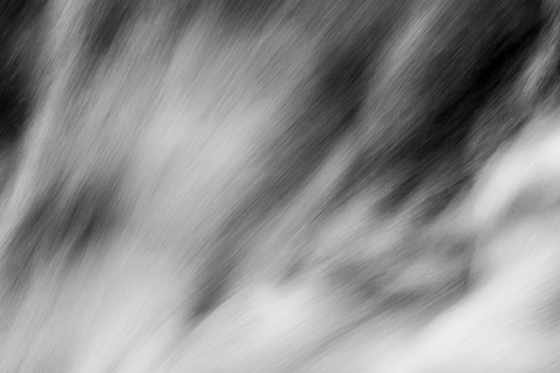 Black and white nature photograph with a minimalist style depicting the force of water